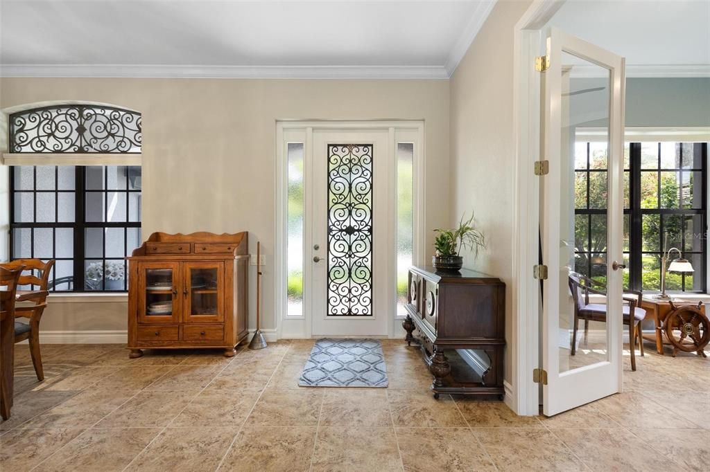 Foyer entry with Office/flex space to the right with French doors, and Formal Dining Room to the left.