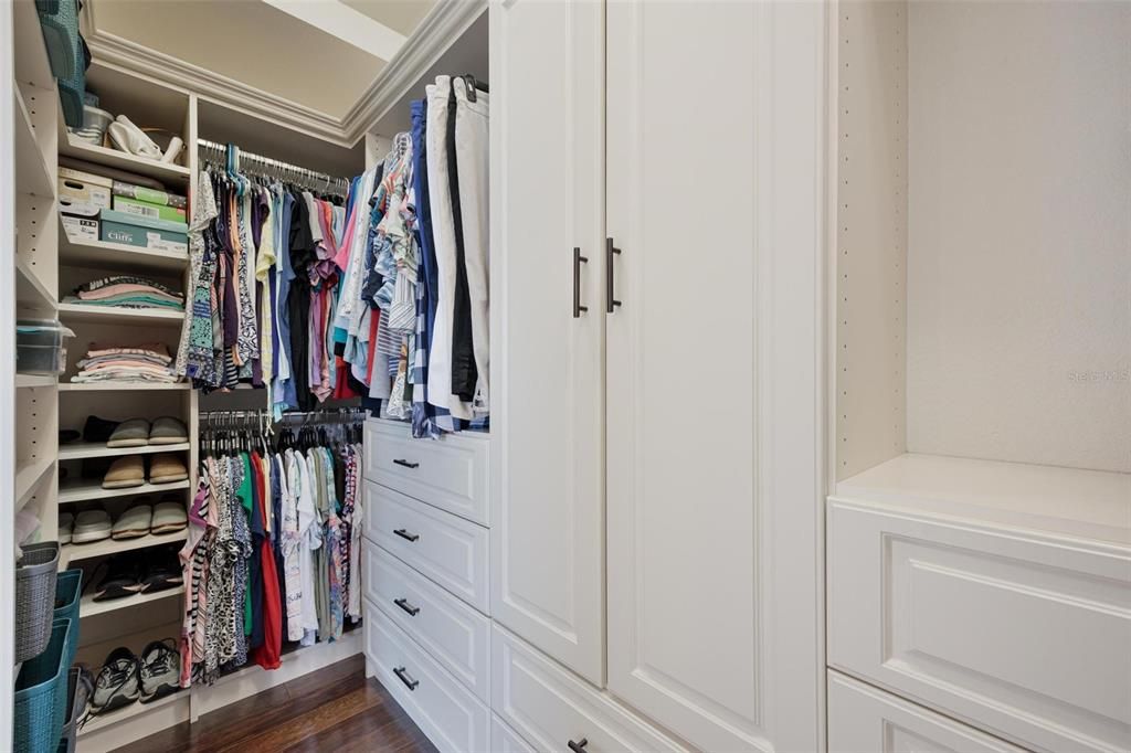 Left side view of the Owner's closet with custom built-ins.