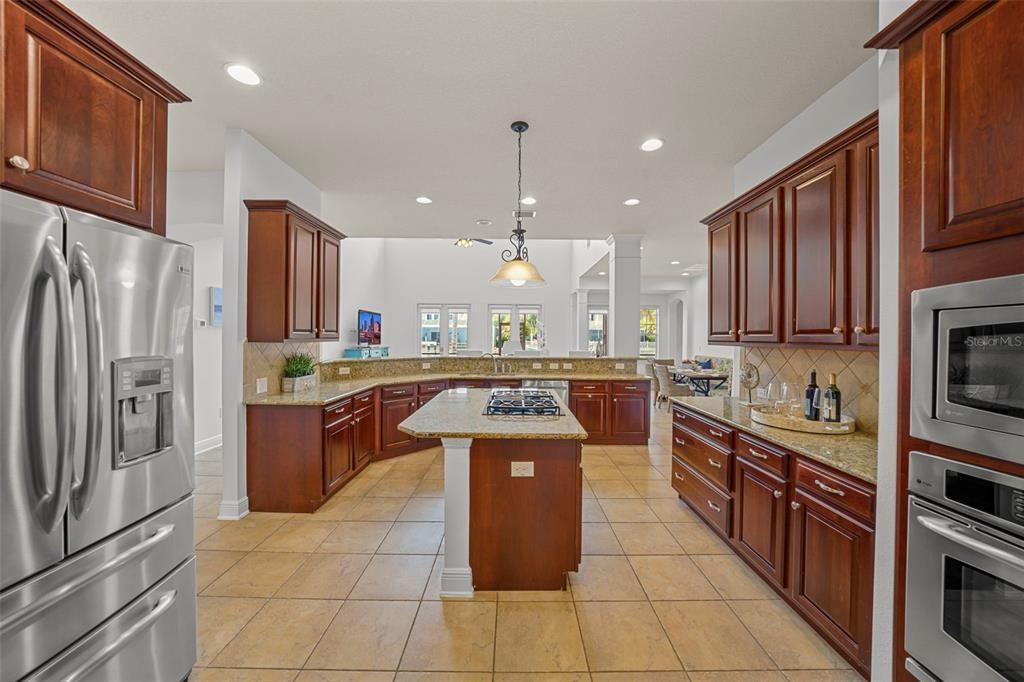 Reverse view of kitchen facing family room and back yard.