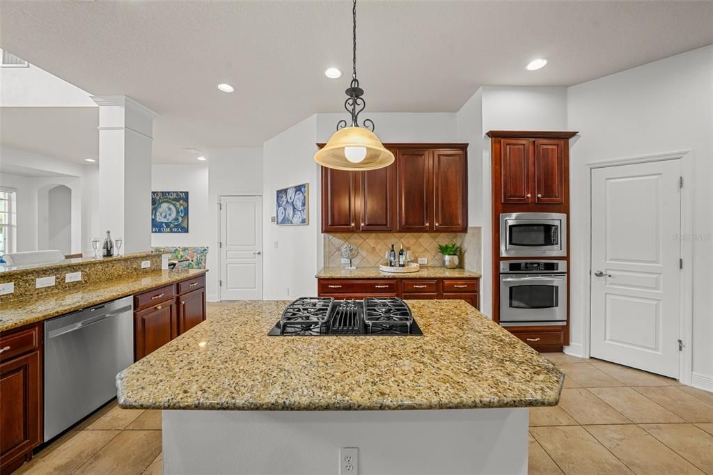 Light filled kitchen features stainless appliances and center island with plenty of cabinet space and pantry.