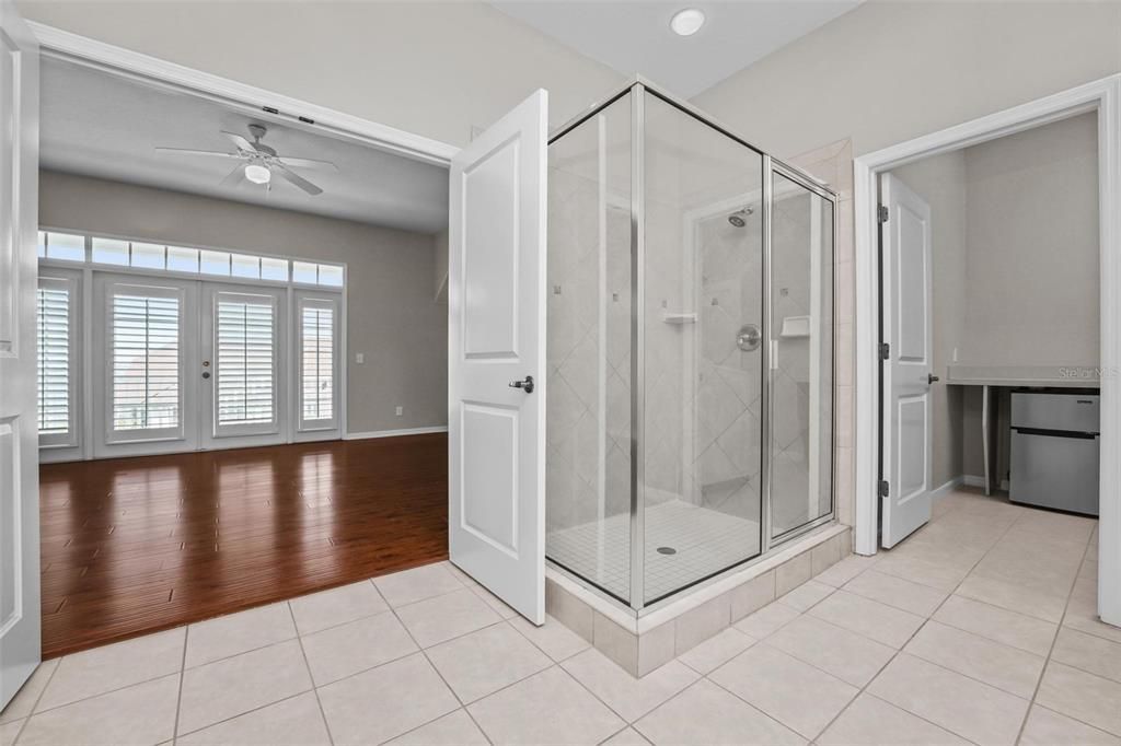 view to owner suite from master bath- stand up shower