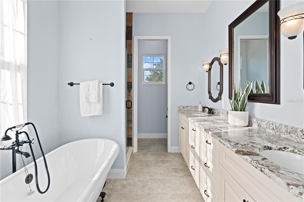 Ensuite bathroom features dual sinks, a large walk-in shower and soaking tub.