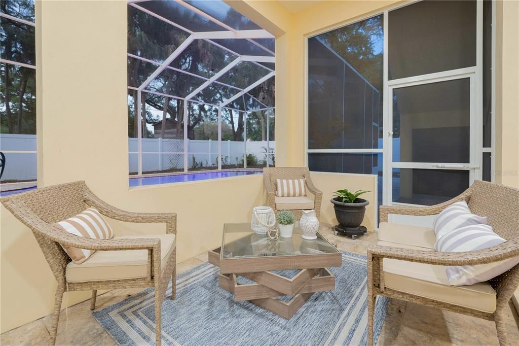 Poolside terrace features a sitting area and space for dining and entertaining.