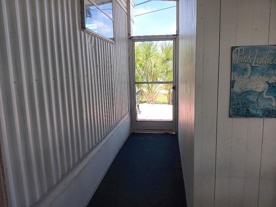 SCREENED AREA LEADS TO SHED OR BACKYARD WITH BREEZEWAY