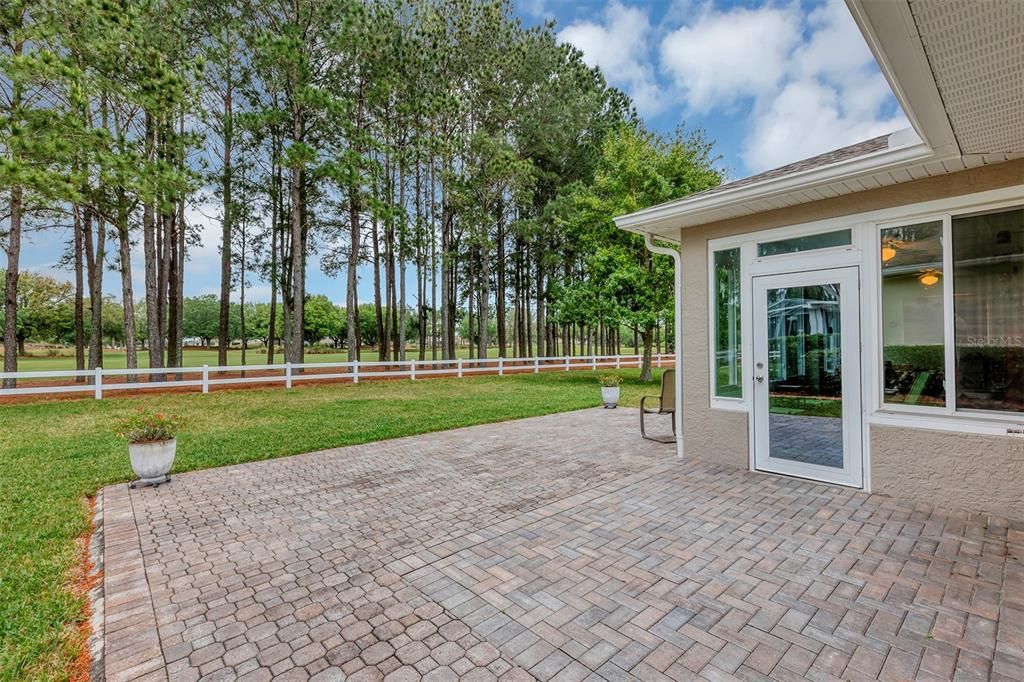 Glass Enclosed lanai with spacious paver patio for grilling and entertaining