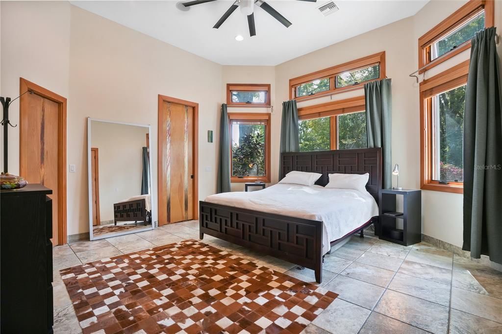 The master retreat is privately located in a split floor plan configuration and features a walk-in closet and oversized commercial ceiling fan.
