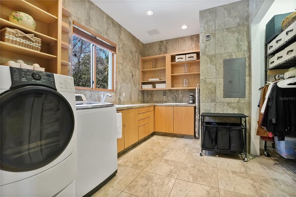 The oversized laundry room offers plenty of space, shelving and countertop to accommodate a large or growing family.  Gas stub out is in place behind the washer and dryer.