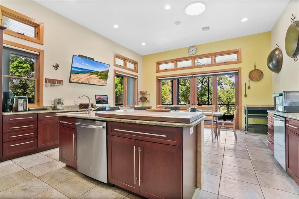 The gourmet kitchen is a chef's dream come through featuring double dishwashers, a cooking island with sink & upgraded level 5 Jaguar granite counter tops.