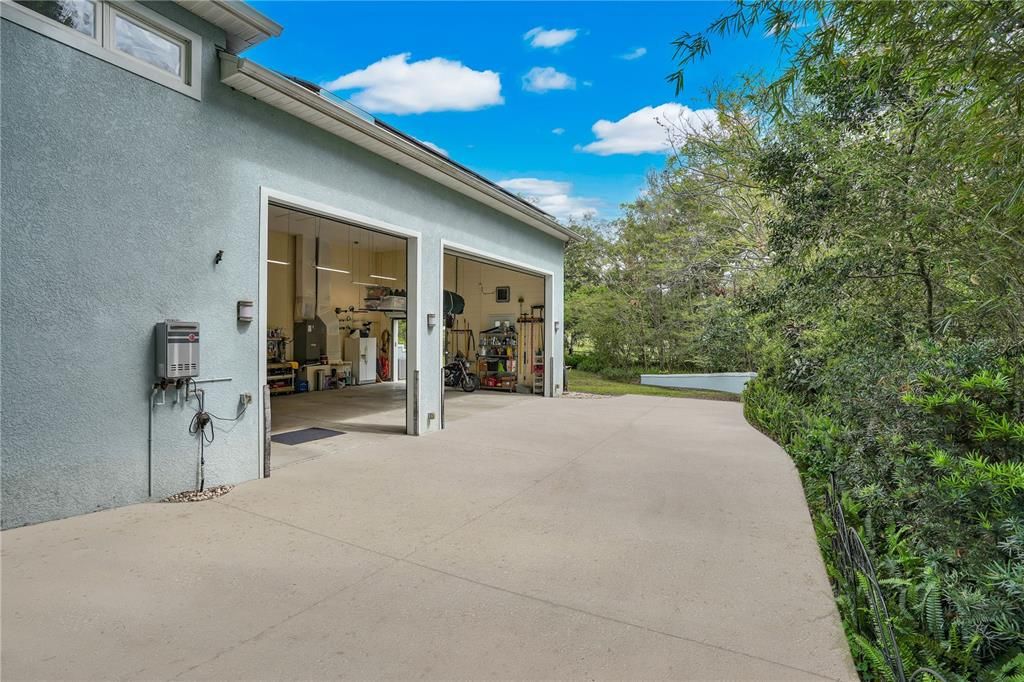 The oversized 25'x34' main house side entry garage with 16' ceilings and 12' roll up motorized garage doors can easily accommodate several car lifts and is perfect to house your exotic automobile collection, RV, ATV's, Motorcycles, or workshop.