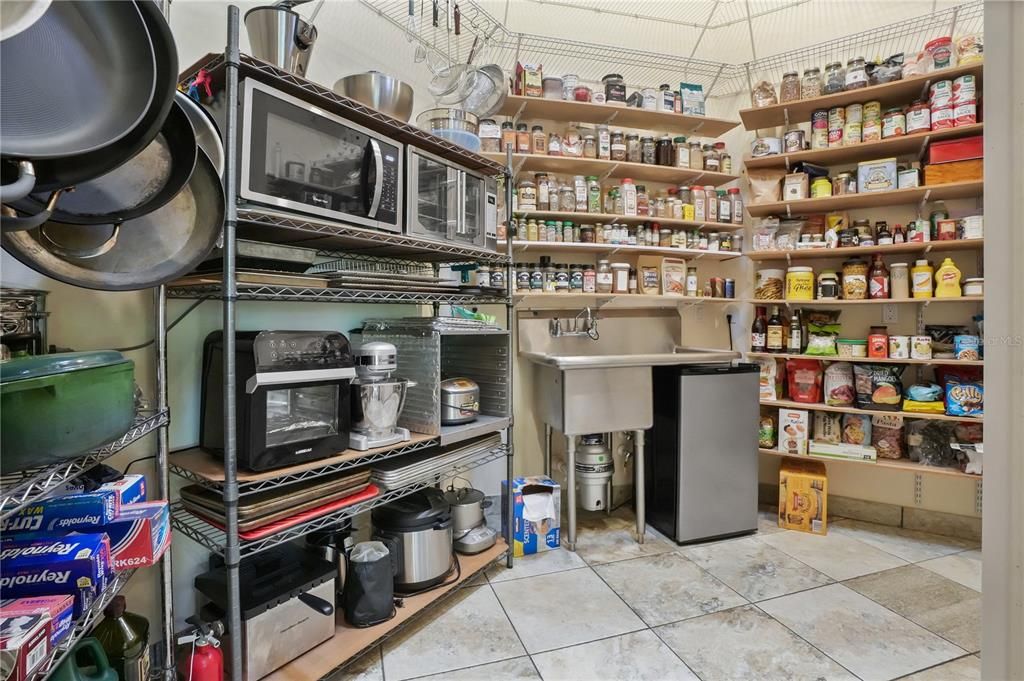 The oversized 9'x12' pantry offers a 3rd commercial sink with pot filler and plenty of shelving to satisfy the most sophisticated culinary aficionado with plenty of shelving to accommodate any ingredients that the most exquisite and decadent recipes call for.