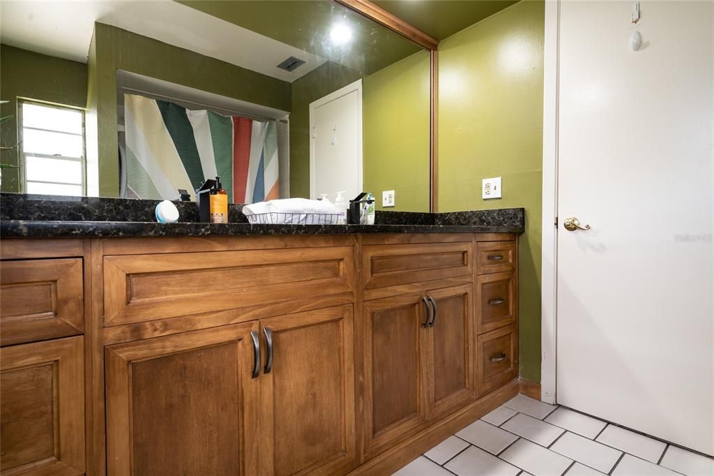 Bathroom #2 features dual sinks with granite countertops.