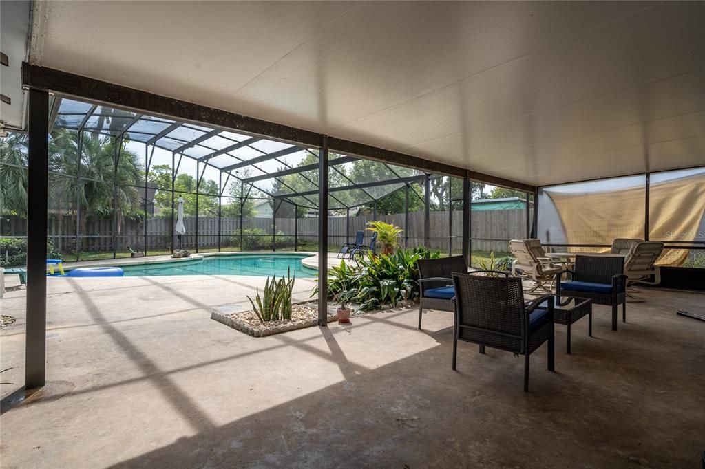 Enjoy the covered big lanai that overlooks the back yard and pool area.