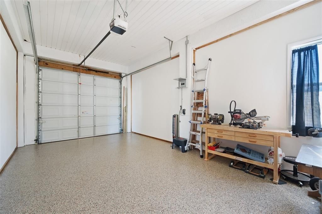 Oversized garage with a NEW stylish wood barn door, plenty of storage cabinets, & NEW Polyurea/polyaspartic Hyrbid Floor Coating.