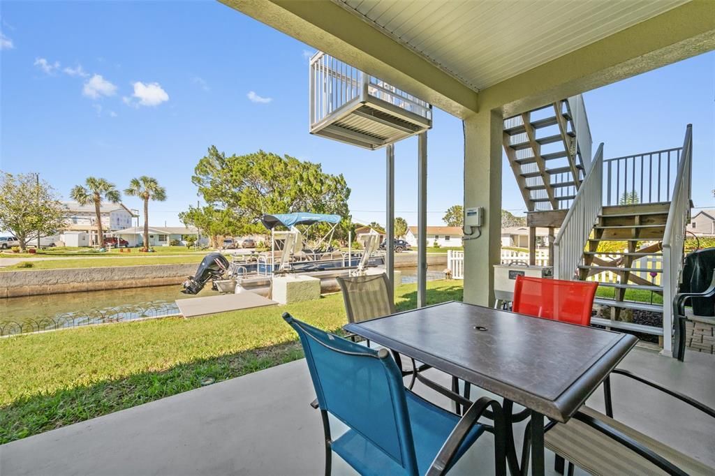 Huge covered rear patio is perfect for entertaining...rain or shine! There is an exterior staircase + Cargo Lift up to 1,000 pounds for convenience!