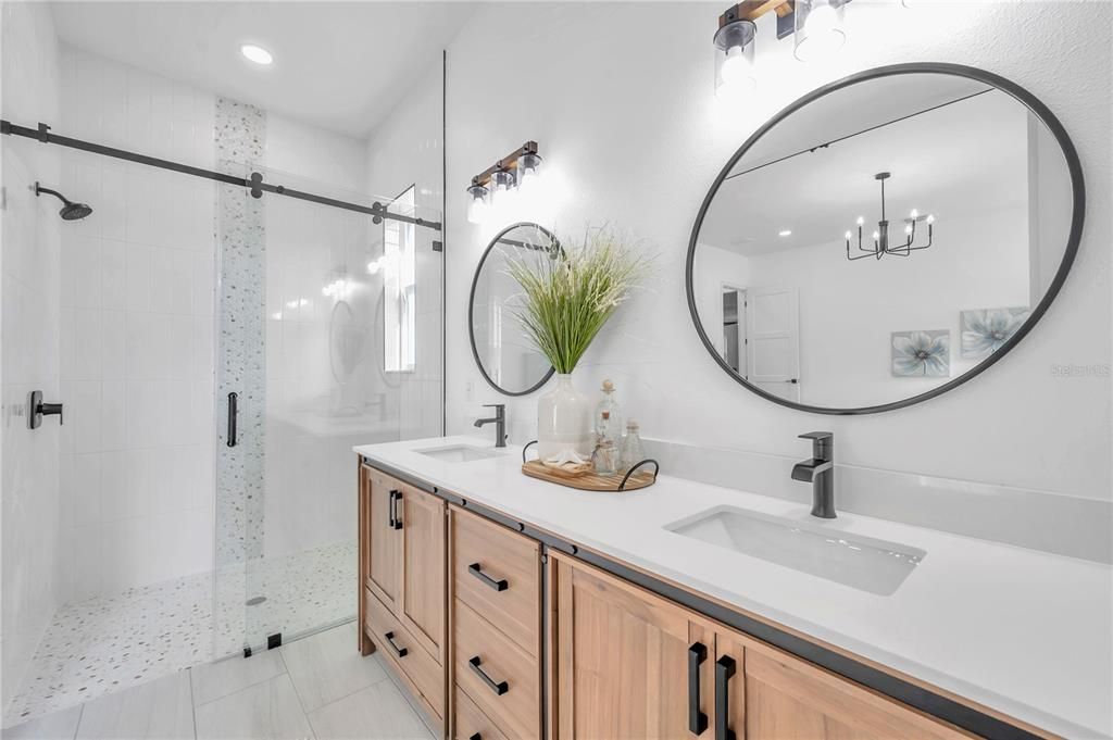 Beautiful Master shower tile work with frame less sliding shower doors