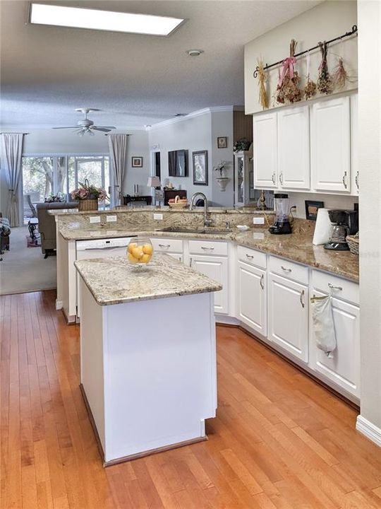 The expansive kitchen features stone countertops and a gas range