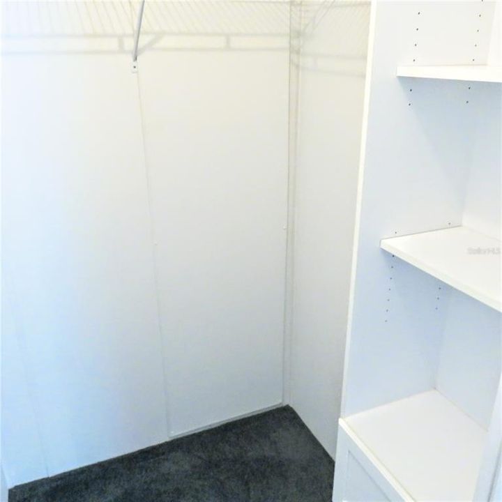 Walk in closet has shelves and closetmaid racks