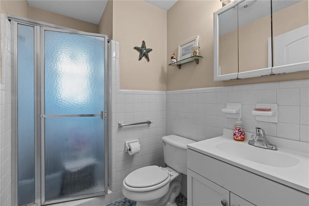 Bathroom #2 has single vanity and  walk-in shower
