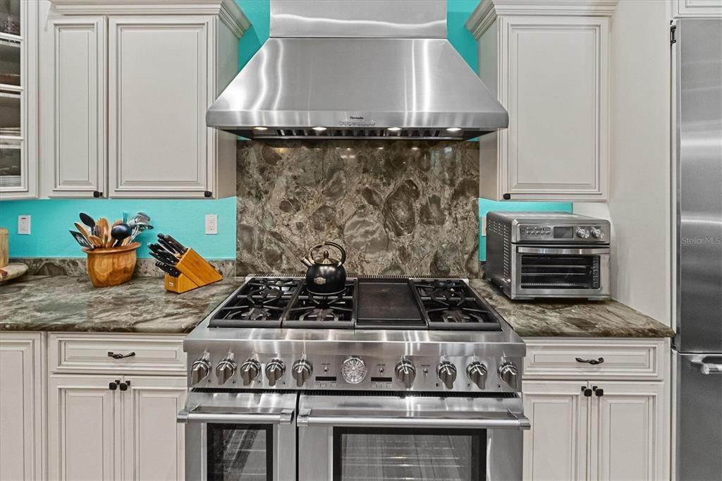 48" Pro series Thermador gas range w griddle & vented Pro chimney hood.