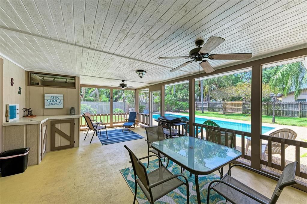 Screened lanai off family room and primary bedroom overlooking the pool