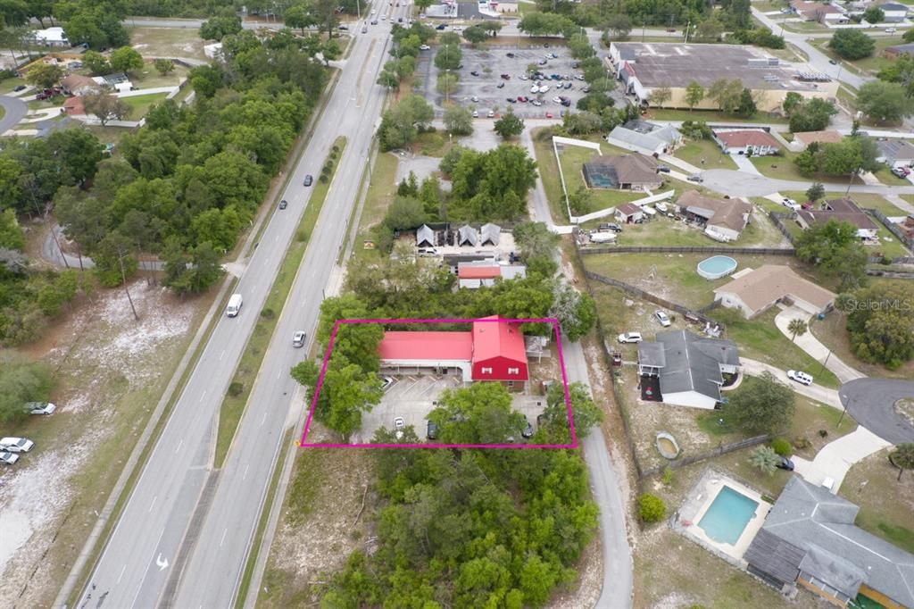 Property is define by the red lines around the building.  Winn Dixie is to the right same side and at the traffic light on the Corner of Howland and Catalina