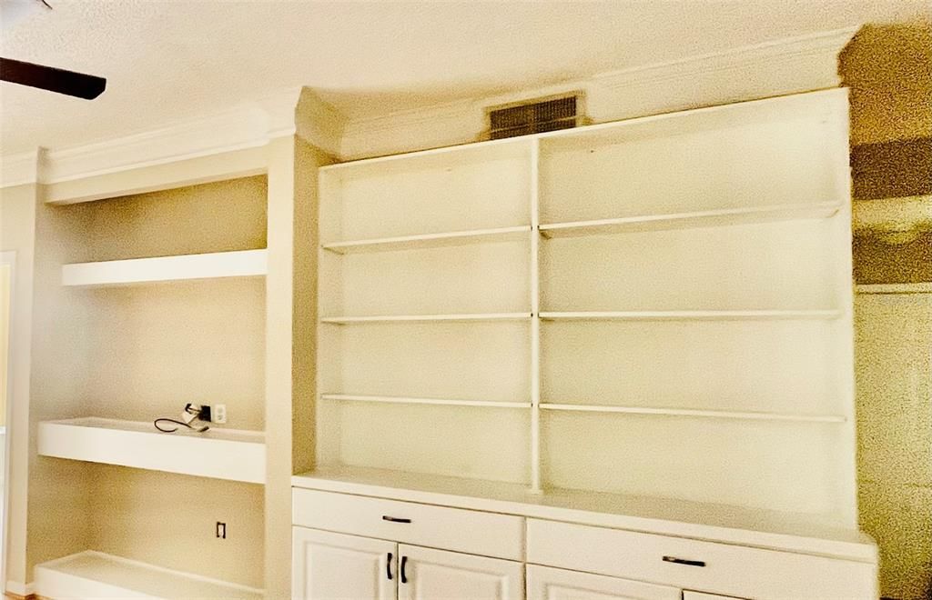 Close up view of built in shelves and custom cabinet