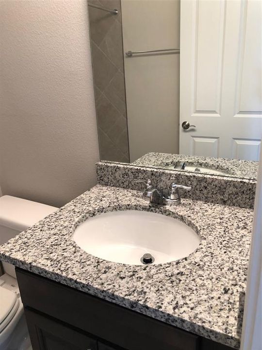 Beautiful granite counters and undermount sink in bedroom 3's private bath.