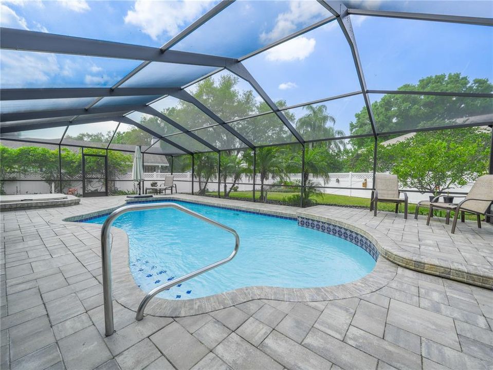 Newer brick pavers surround pool