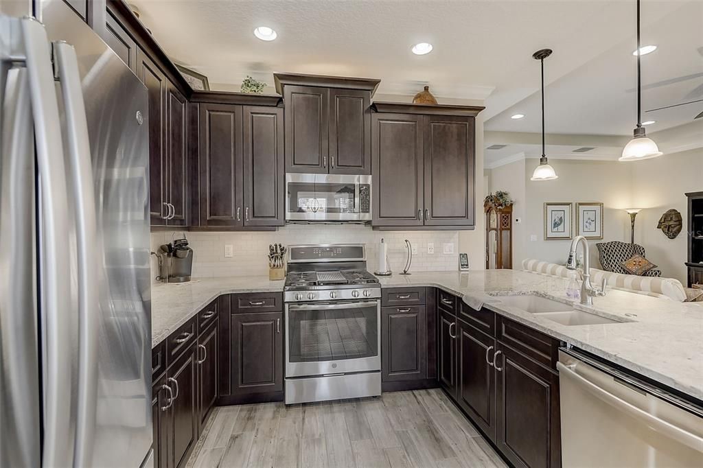 KITCHEN FEATURING 42' ESPRESSO CABINETRY, ALL TOP OF THE LINE GE STAINLESS STEEL CABINETS, CONVECTION OVEN AND AIRFRY MICROWAVE, GRANITE COMPOSITE SINK