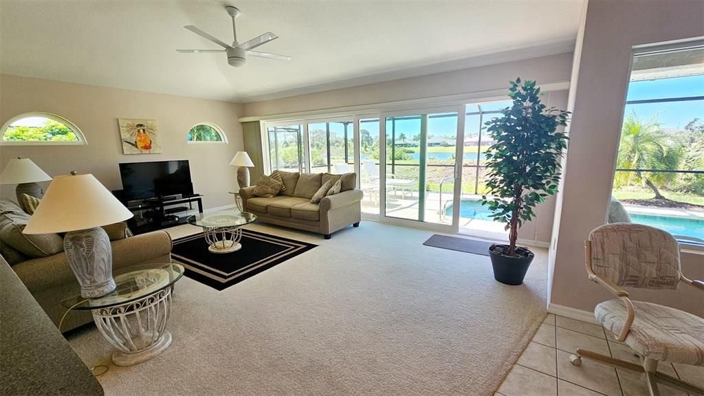 You'll love the family room with a wall of windows and stunning pool and lake views