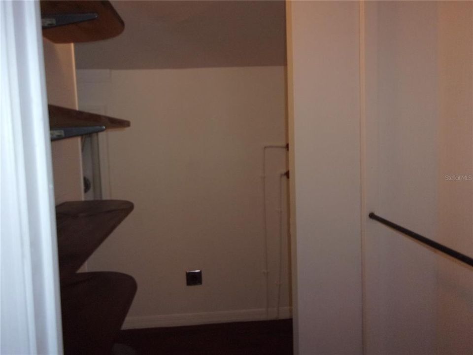 View of closet with shelves as well as a clothes bar