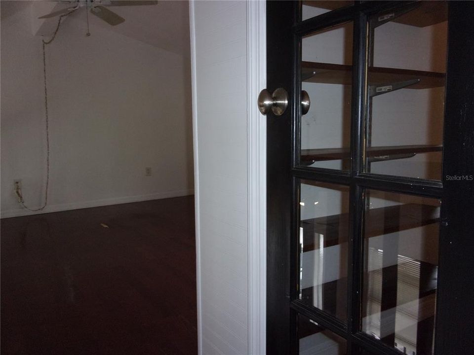 the glass door is to the walk in closet and large bedroom is to the left