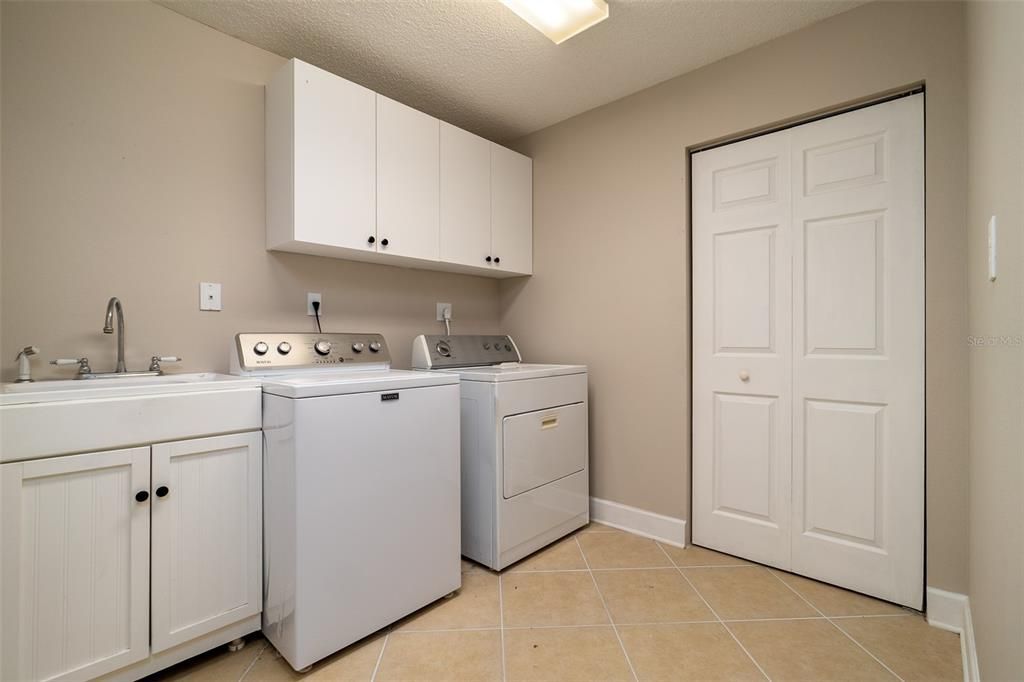 Extra-large laundry room with closet and sink.