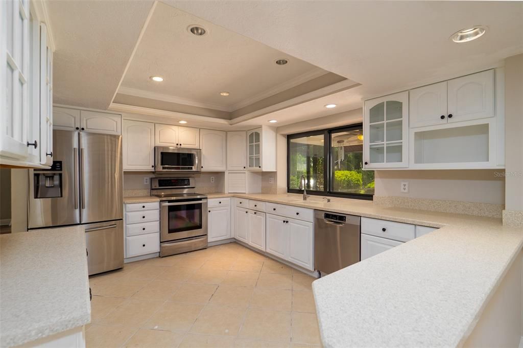Huge kitchen with stainless appliances and tons of cabinets.