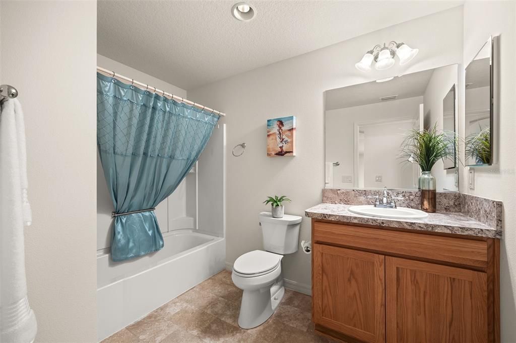 Guest bath with tub/shower combo.