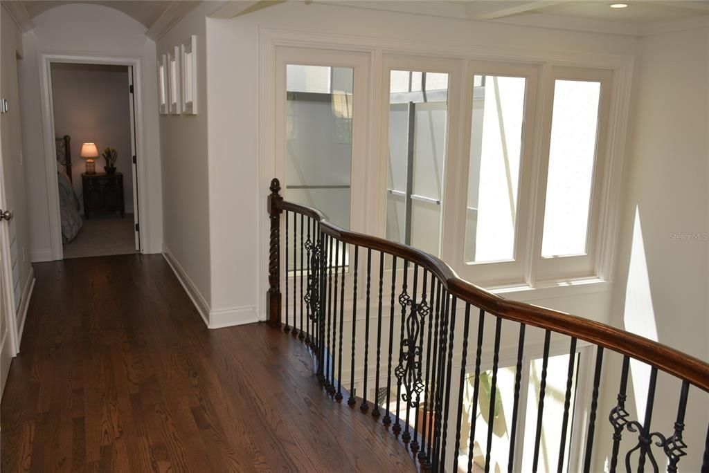 The second level of the staircase opens to an expansive balcony with brand new hardwood floors overlooking  living room & atrium