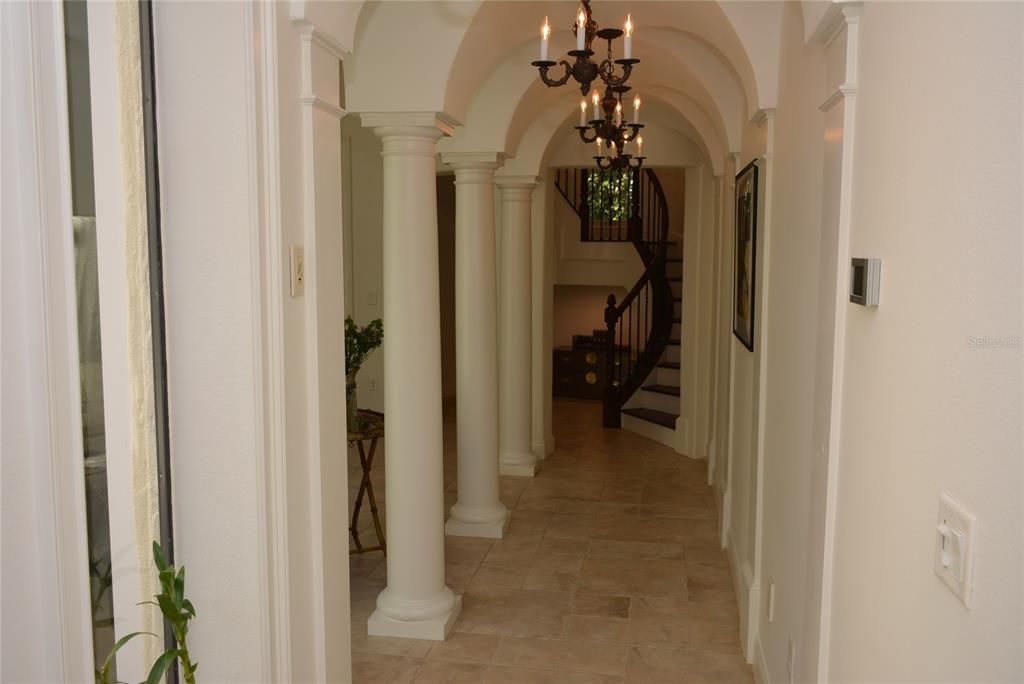 Columned walkway leads to the family room and eat-in kitchen with center island.