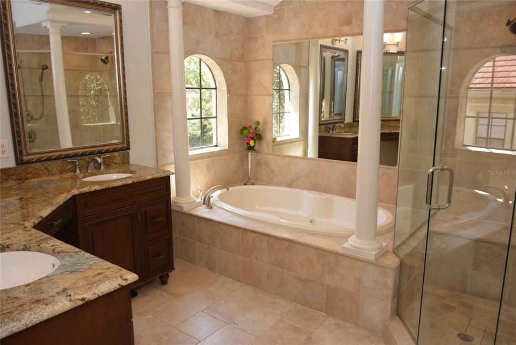 Luxurious bath including expansive double vanity, oversize Kohler jetted tub and glass shower
