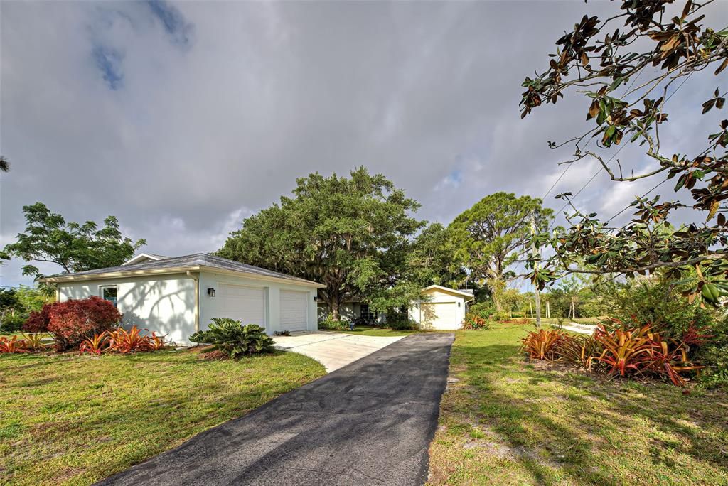 MATURE LANDSCAPING. ATTACHED ONE CAR GARAGE AND DETACHED OVERSIZED TWO CAR GARAGE/ WORKSHOP.