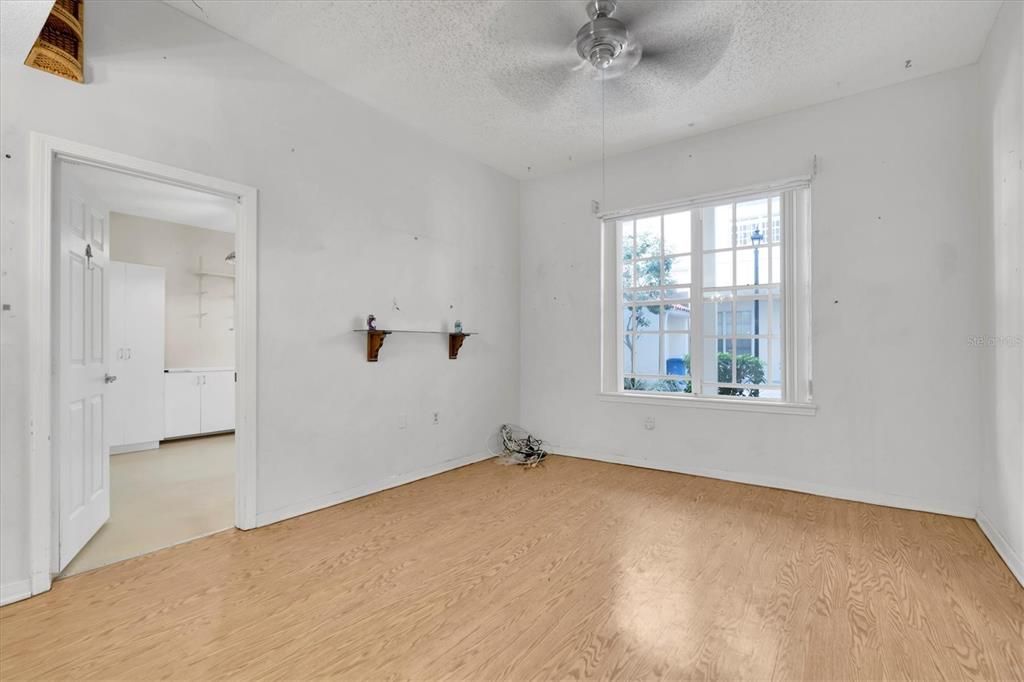 Living area has nice windows peeking out to the quiet courtyard. Door leads into primary bedroom