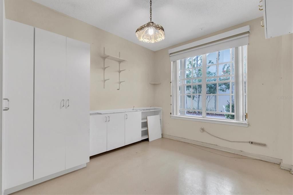 Primary bedroom. More windows to the courtyard and currently substantial built in closet and storage space. Something you could keep, update or open up the room without