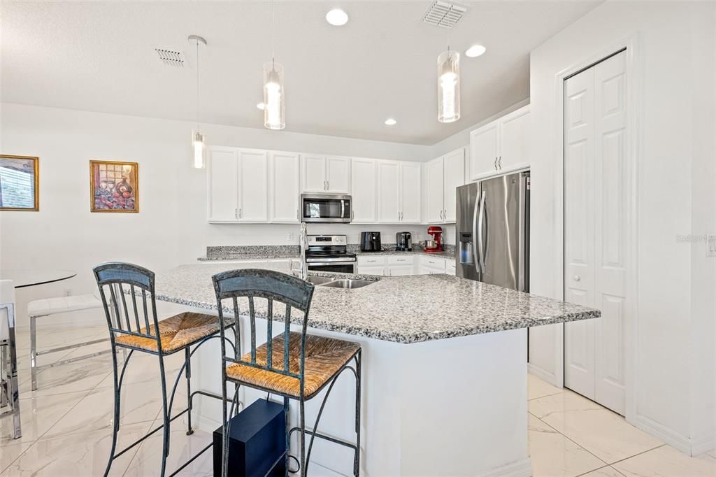 Kitchen with stainless steel appliances and quartz countertops
