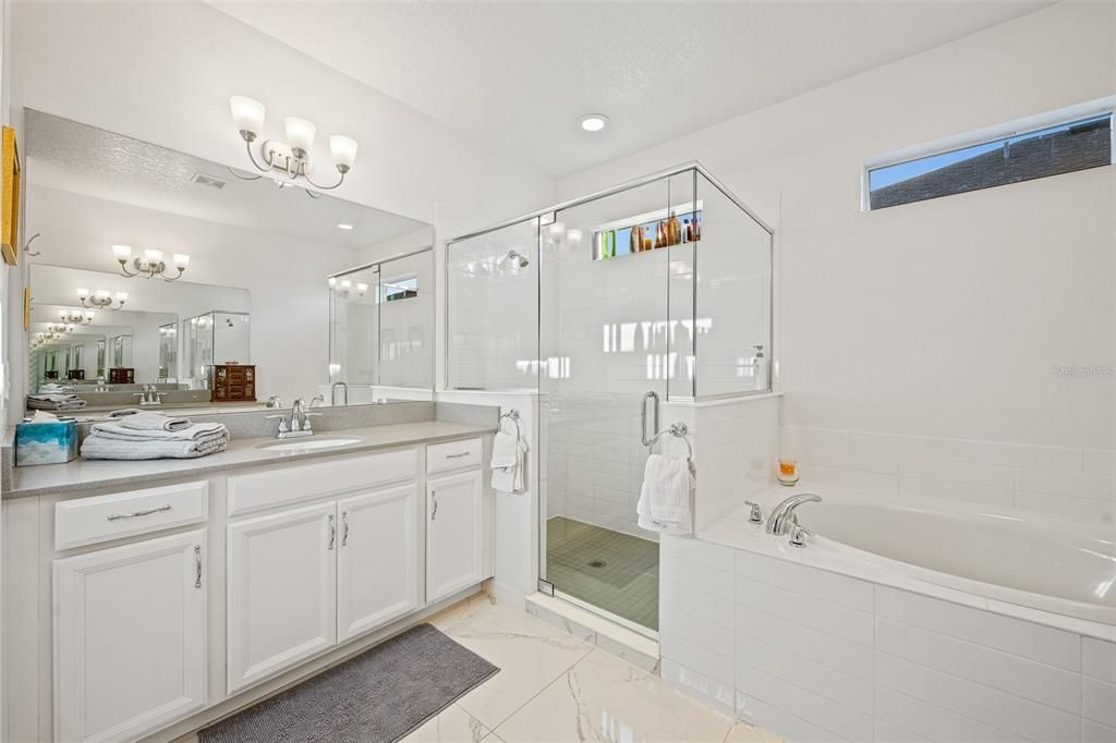Master bath with tub and walk-in shower
