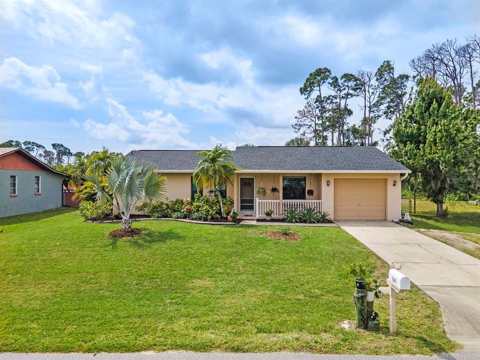 Welcome Home. Beautiful mature landscaping with concrete curbing.