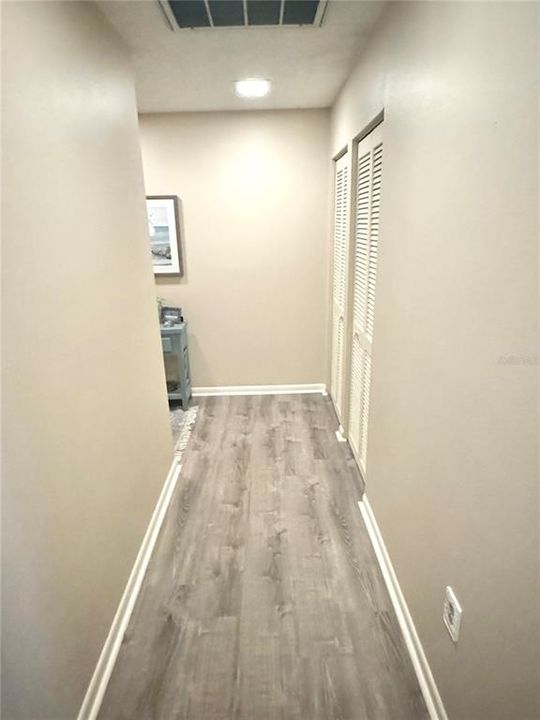 New vinyl laminate flooring in the entry hallway and kitchen.