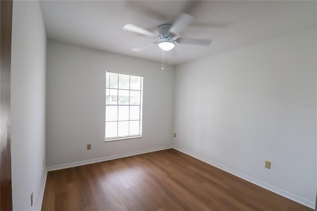 The third bedroom with a ceiling fan.