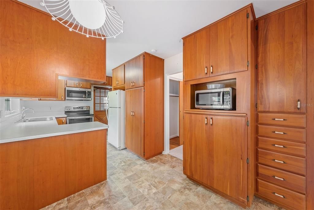 Solid wood kitchen cabinets with laminate countertop. Lots of storage.