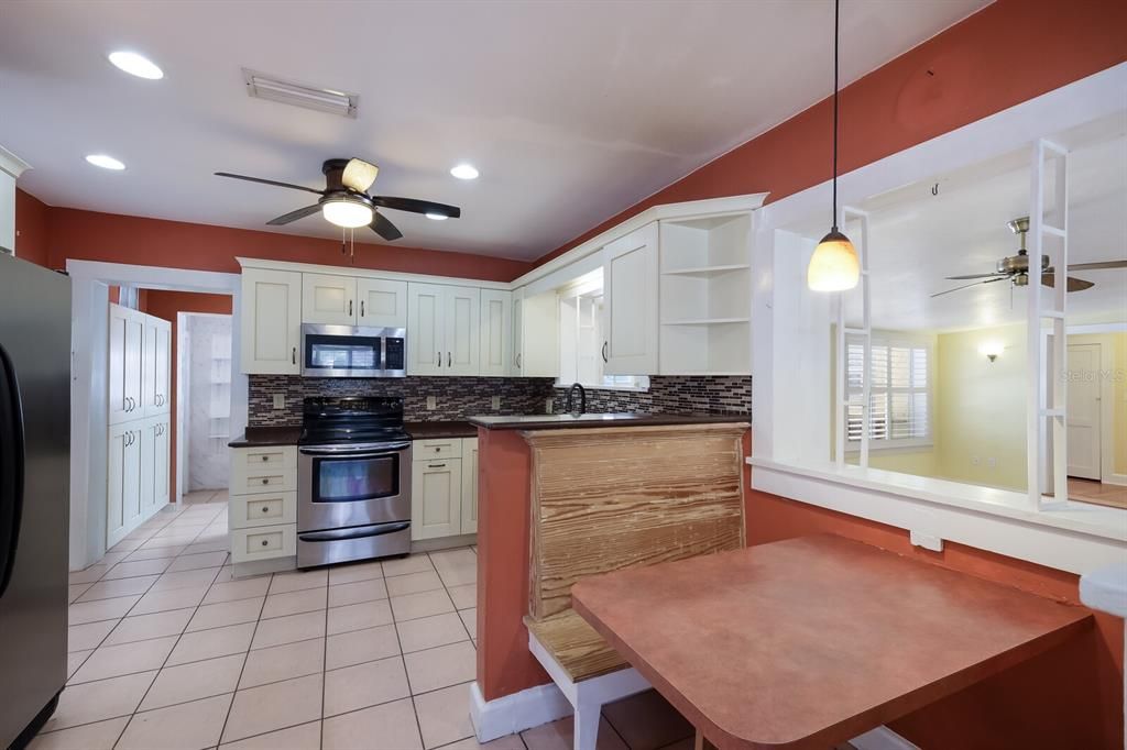 Tile backsplash, good counter space w/ granite counters and large pantry off the kitchen