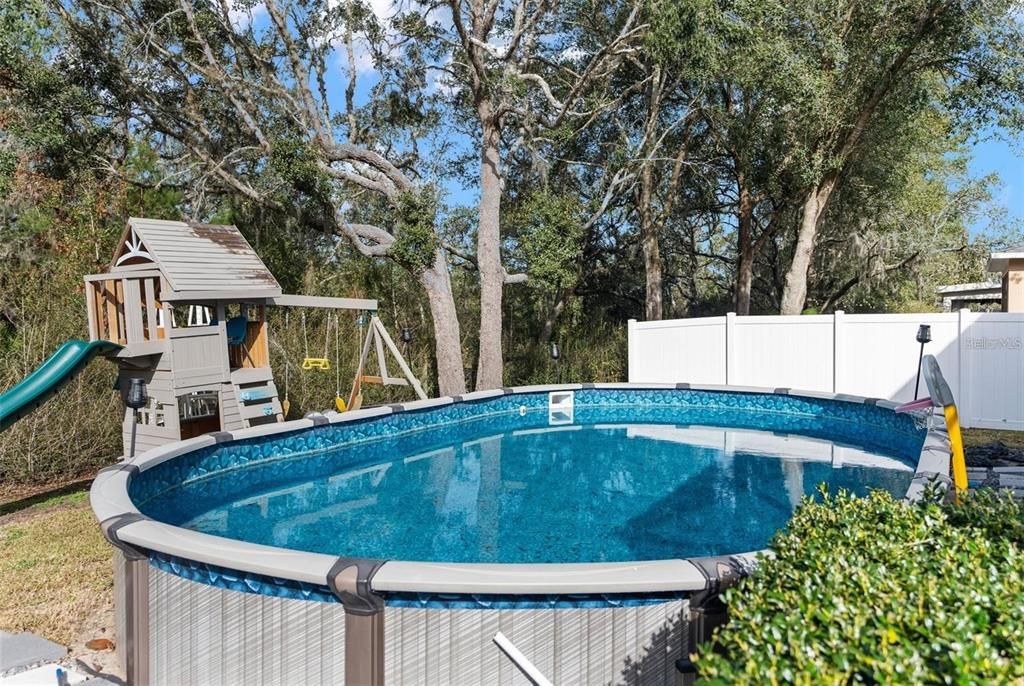 View of background with above ground pool - 12119 DEERTRACK LOOP