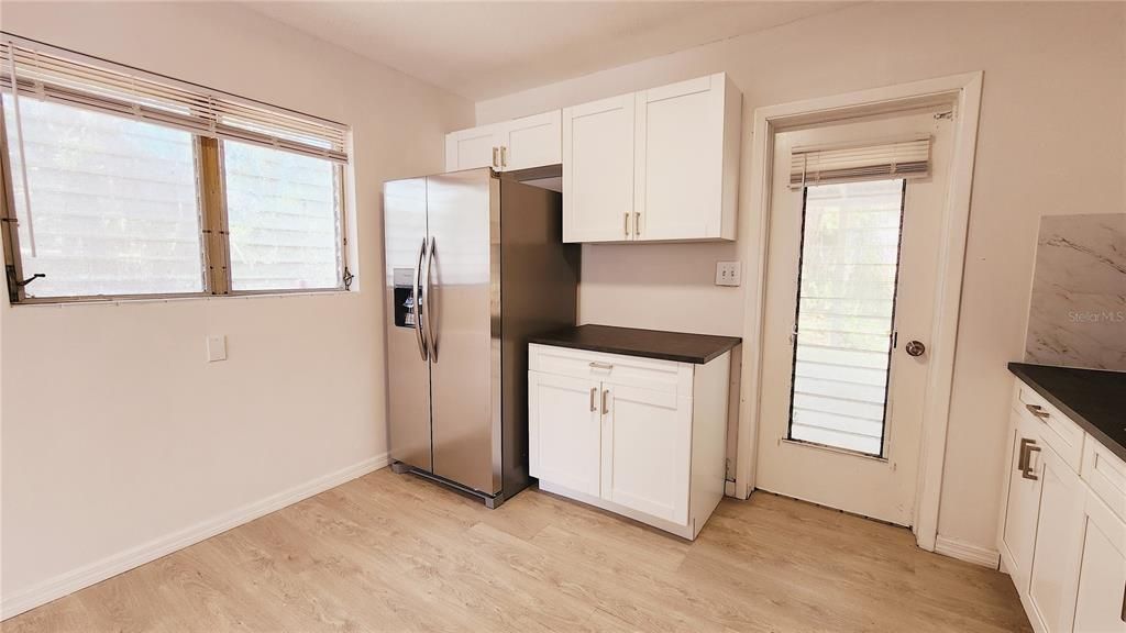 View of the kitchen with access to the backyard.